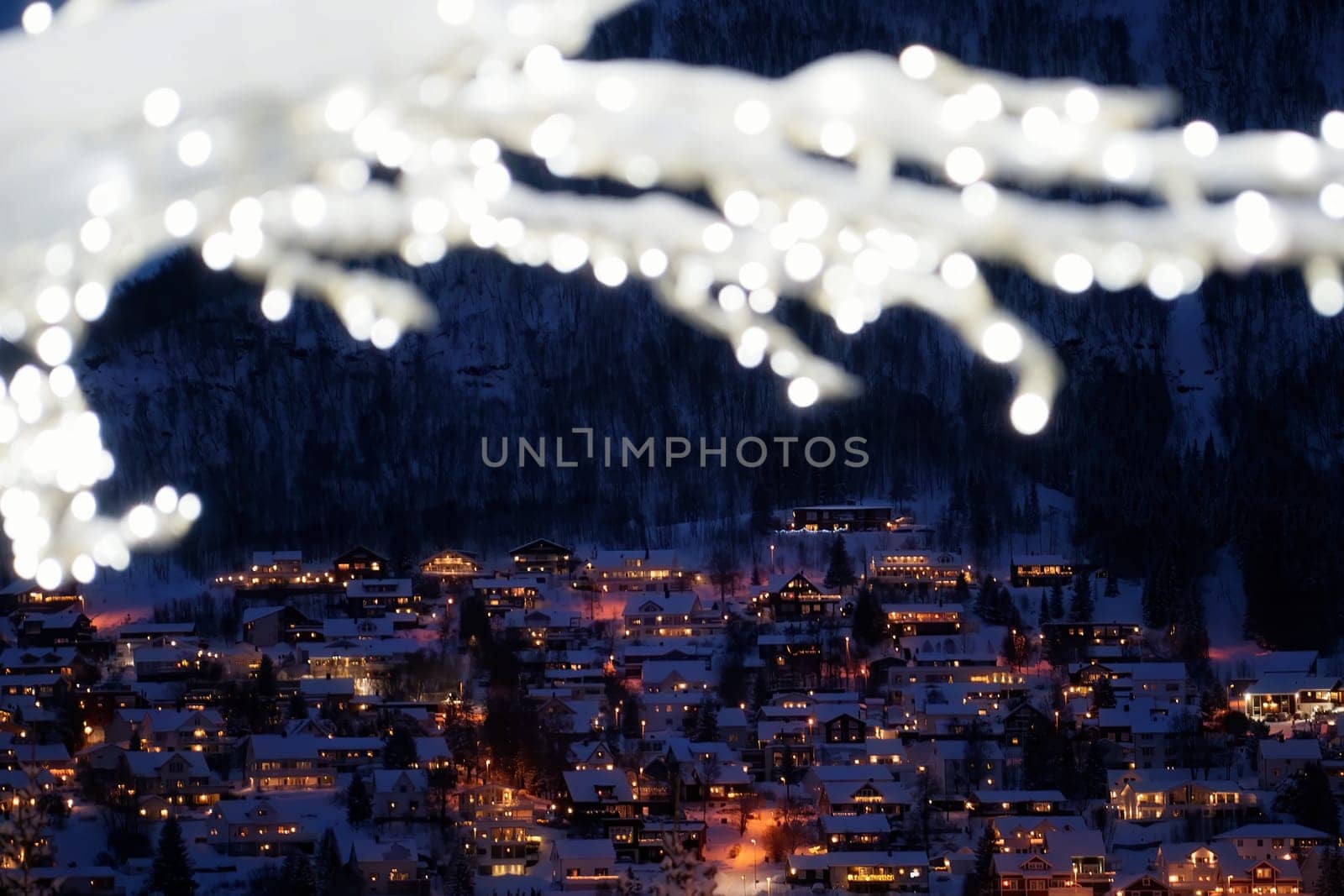 Defocused winter tree with lights and decorations in Tromso town, Northern Norway
