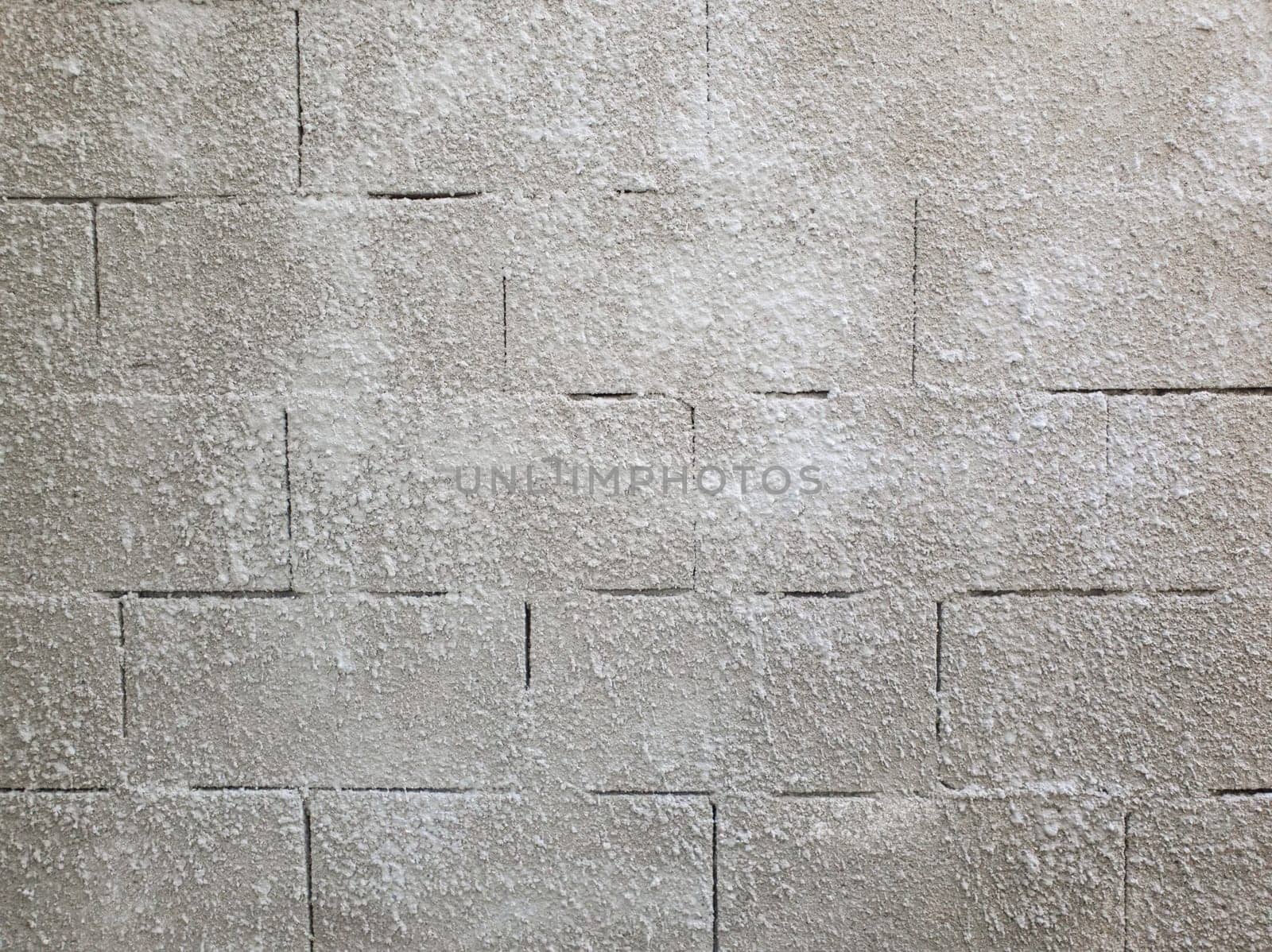 Old grey stone masonry wall texture made of foam blocks or airblocks. Abstract surface plastered. Grunge, weathered construction structure.