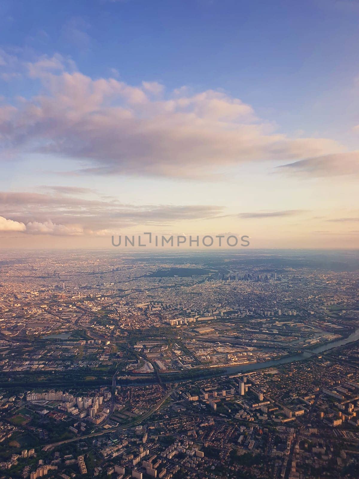 Aerial cityscape view from a plane over St Denis district and Seine river in Paris, France.