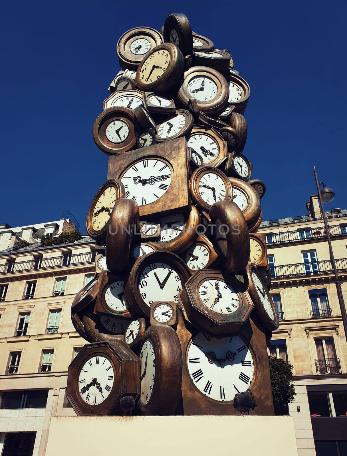 L'Heure de Tous monument, Art sculpture made of clocks at Saint-Lazare train station, Paris France. Popular tourist landmark as time of everybody concept, showing different hours.