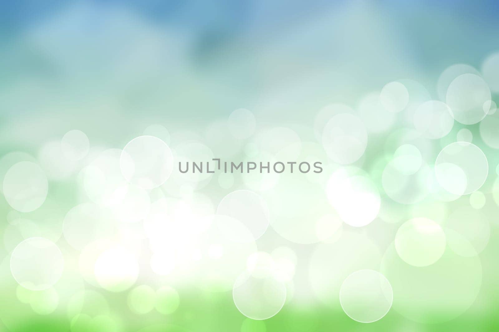 Abstract bright spring or summer landscape texture with natural light green bokeh lights and blue bright sunny sky with clouds. Autumn or summer background with copy space.