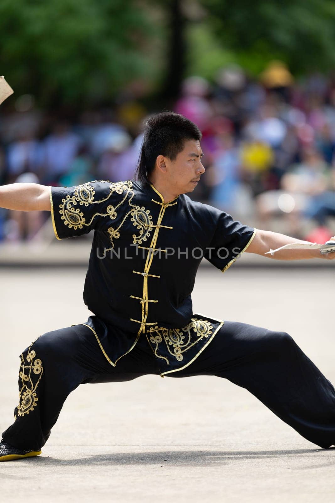 Columbus, Ohio, USA - May 26, 2019: Columbus Asian Festival, Franklin Park, Man using double Duilian Broadswords, fighting two men with Sticks
