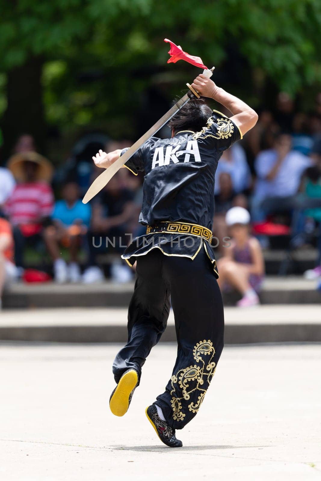 Columbus, Ohio, USA - May 26, 2019: Columbus Asian Festival, Franklin Park, Man wearing traditional chinese clothing handling a Kungfu broadsword during the festival