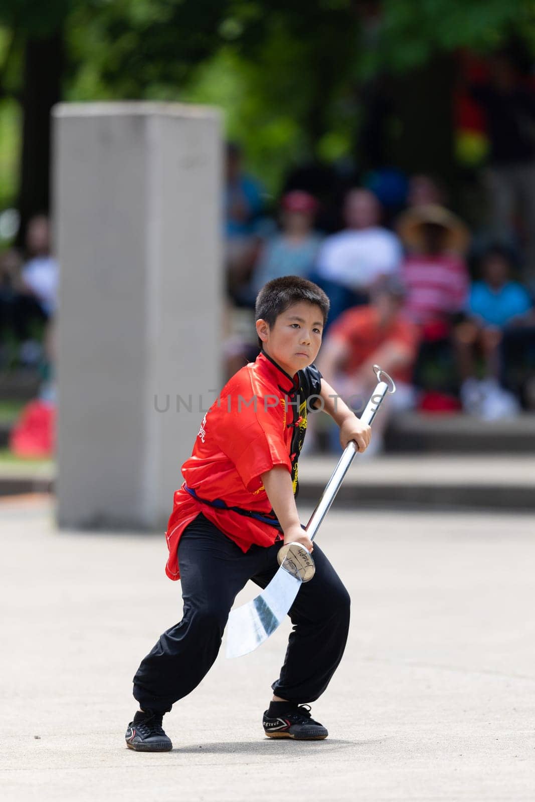 Columbus, Ohio, USA - May 26, 2019: Columbus Asian Festival, Franklin Park, Boy using traditional chinese clothing, handling a Pu Dao Halberd