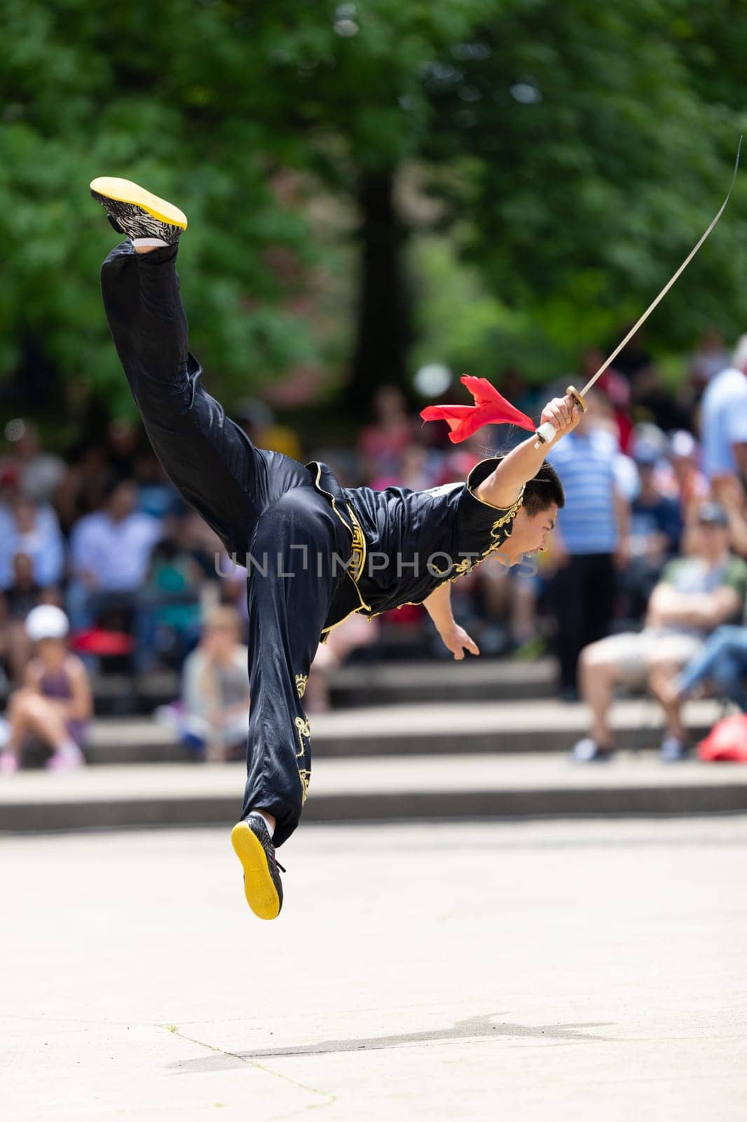Columbus, Ohio, USA - May 26, 2019: Columbus Asian Festival, Franklin Park, Man wearing traditional chinese clothing handling a Kungfu broadsword during the festival
