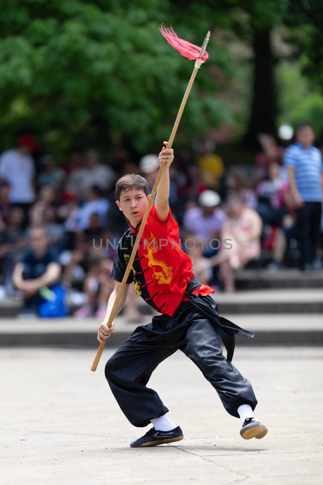 Columbus, Ohio, USA - May 26, 2019: Columbus Asian Festival, Franklin Park, Boy wearing traditional chinese clothing handling a Kung Fu Spear.