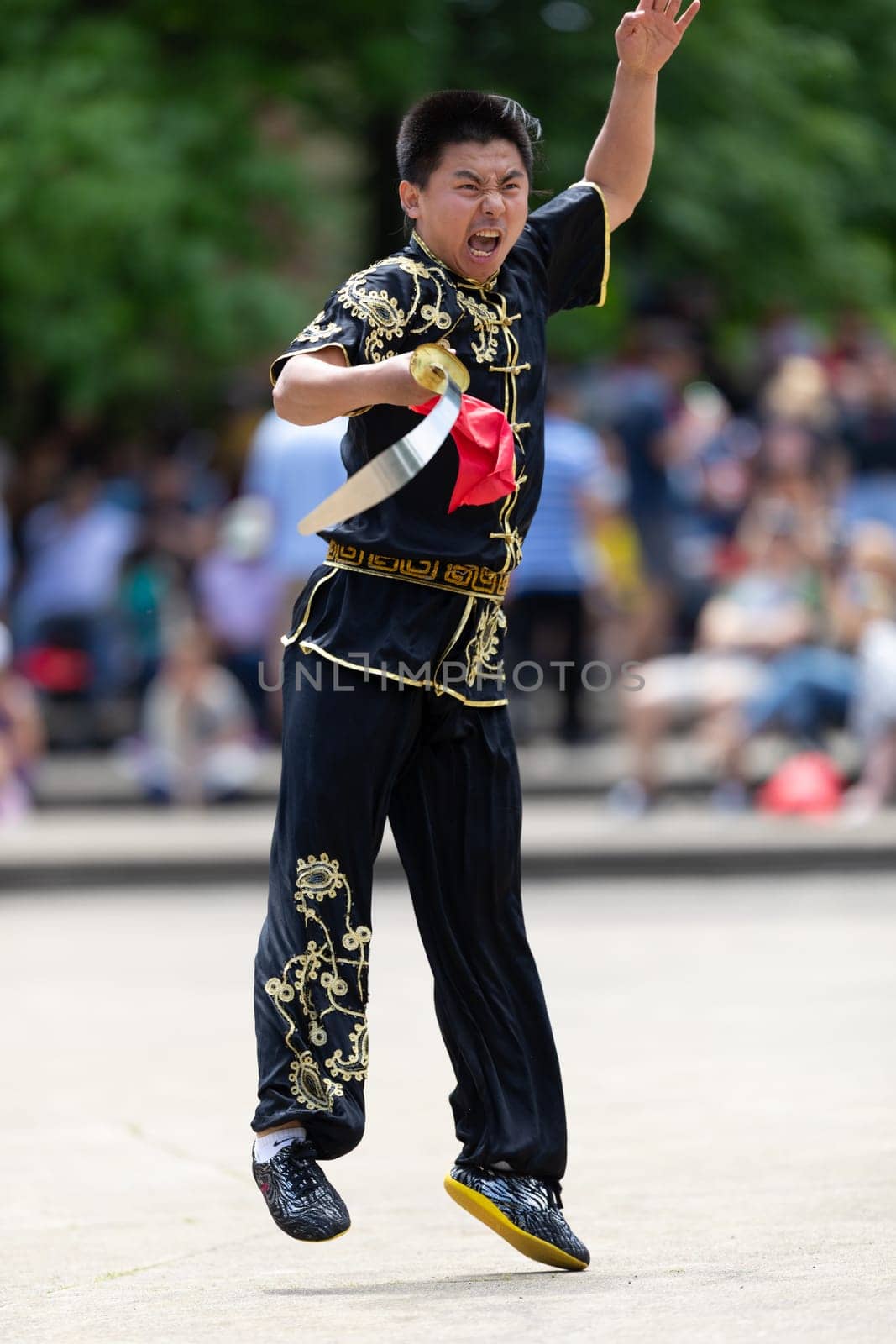 Columbus, Ohio, USA - May 26, 2019: Columbus Asian Festival, Franklin Park, Man wearing traditional chinese clothing handling a Kungfu broadsword during the festival
