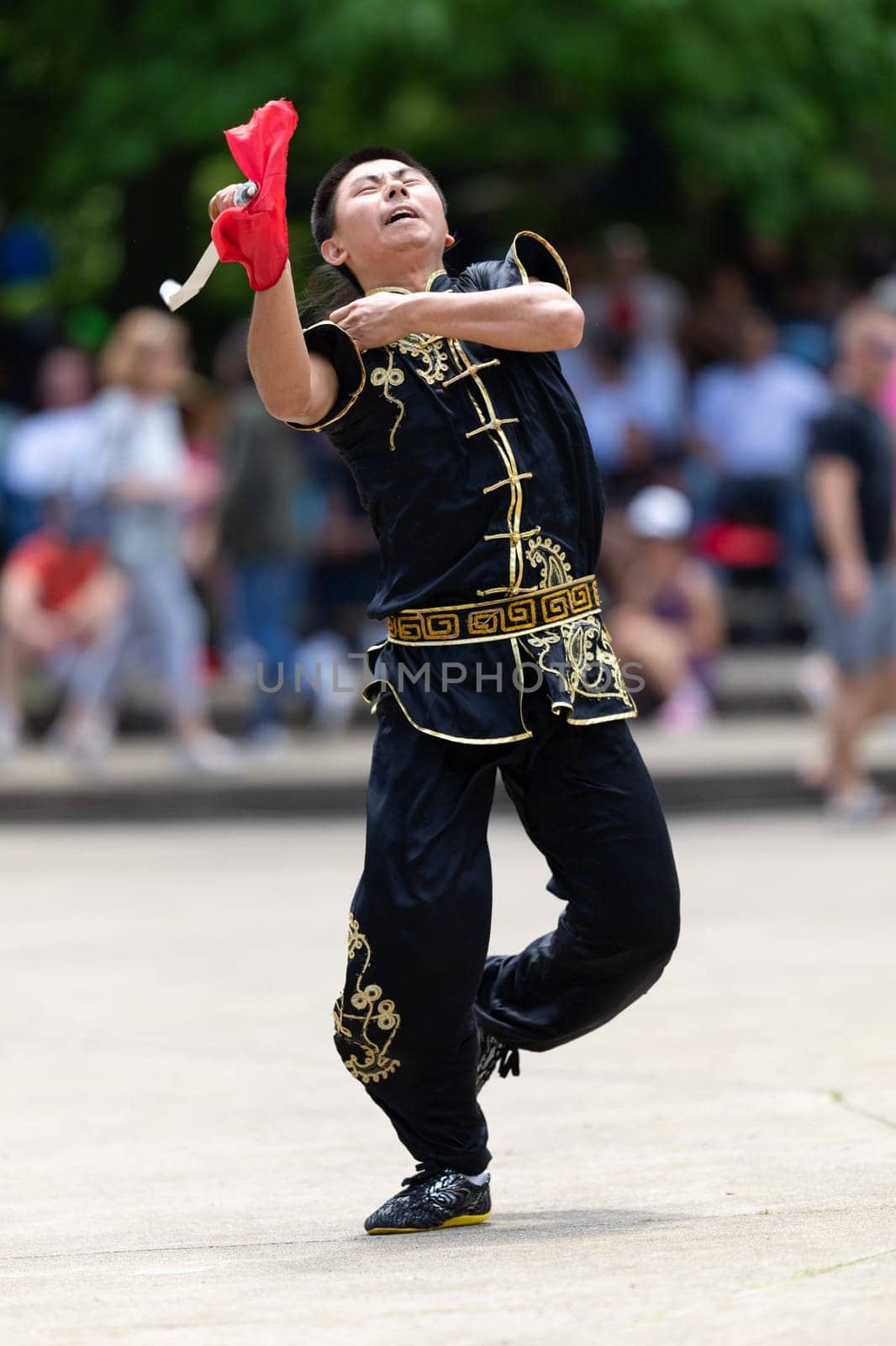 Columbus, Ohio, USA - May 26, 2019: Columbus Asian Festival, Franklin Park, Man wearing traditional chinese clothing handling a Kungfu broadsword during the festival