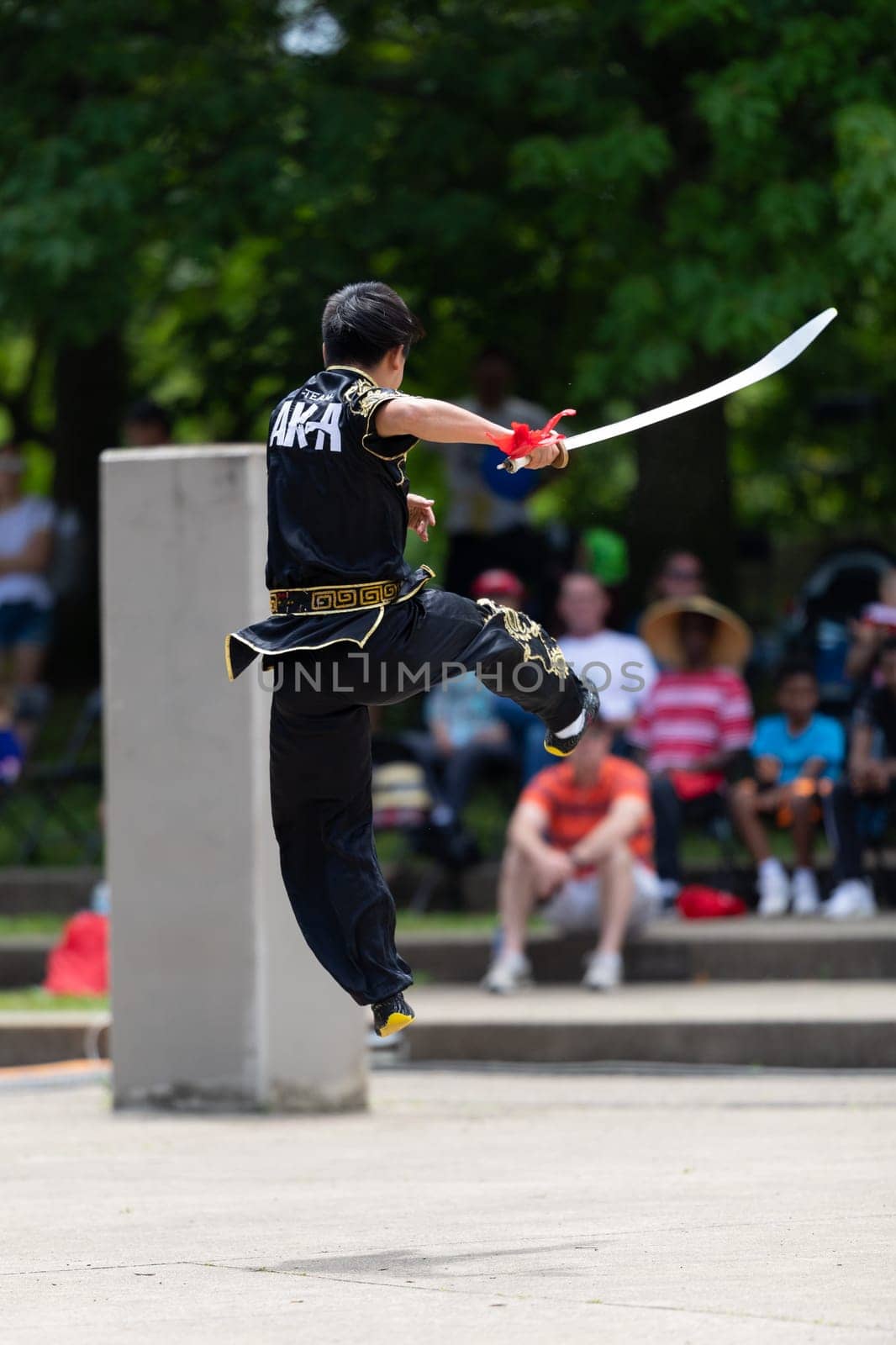 Columbus, Ohio, USA - May 26, 2019: Columbus Asian Festival, Franklin Park, Man wearing traditional chinese clothing handling a Kungfu broadsword during the festival