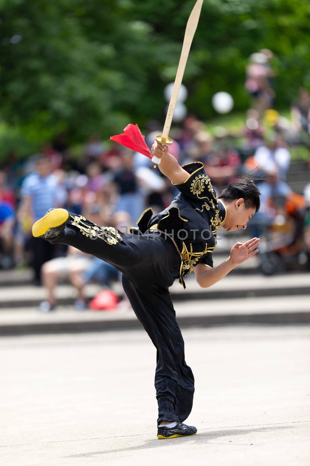 Columbus, Ohio, USA - May 26, 2019: Columbus Asian Festival, Franklin Park, Man wearing traditional chinese clothing handling a Kungfu broadsword during the festival