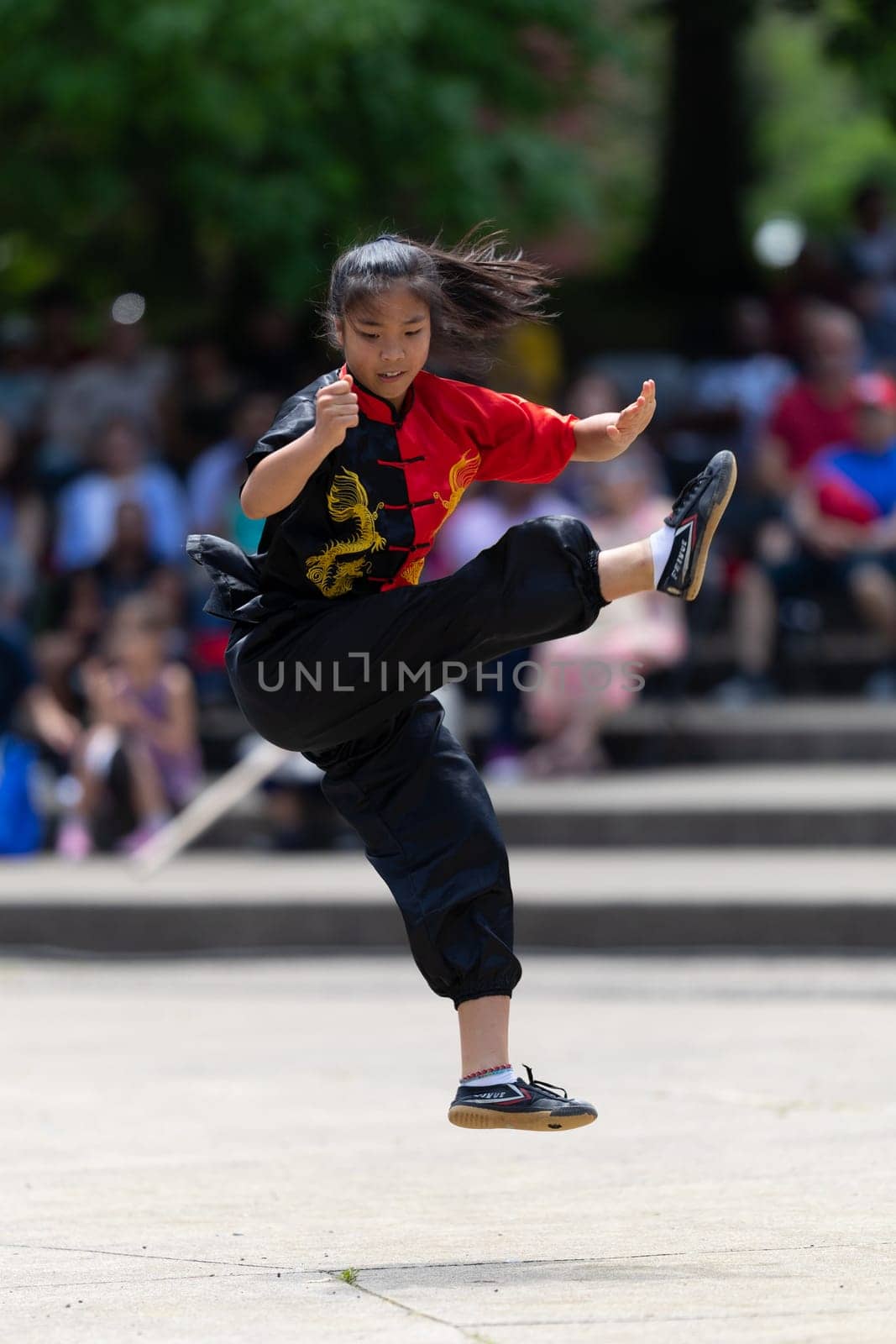 Columbus, Ohio, USA - May 26, 2019: Columbus Asian Festival, Franklin Park, young woman wearing traditional chinese clothing performing a display from Wushu Academy martial arts