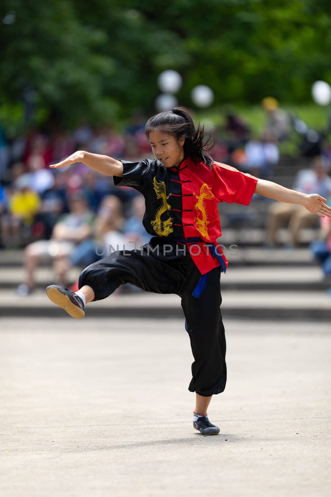 Columbus, Ohio, USA - May 26, 2019: Columbus Asian Festival, Franklin Park, young woman wearing traditional chinese clothing performing a display from Wushu Academy martial arts