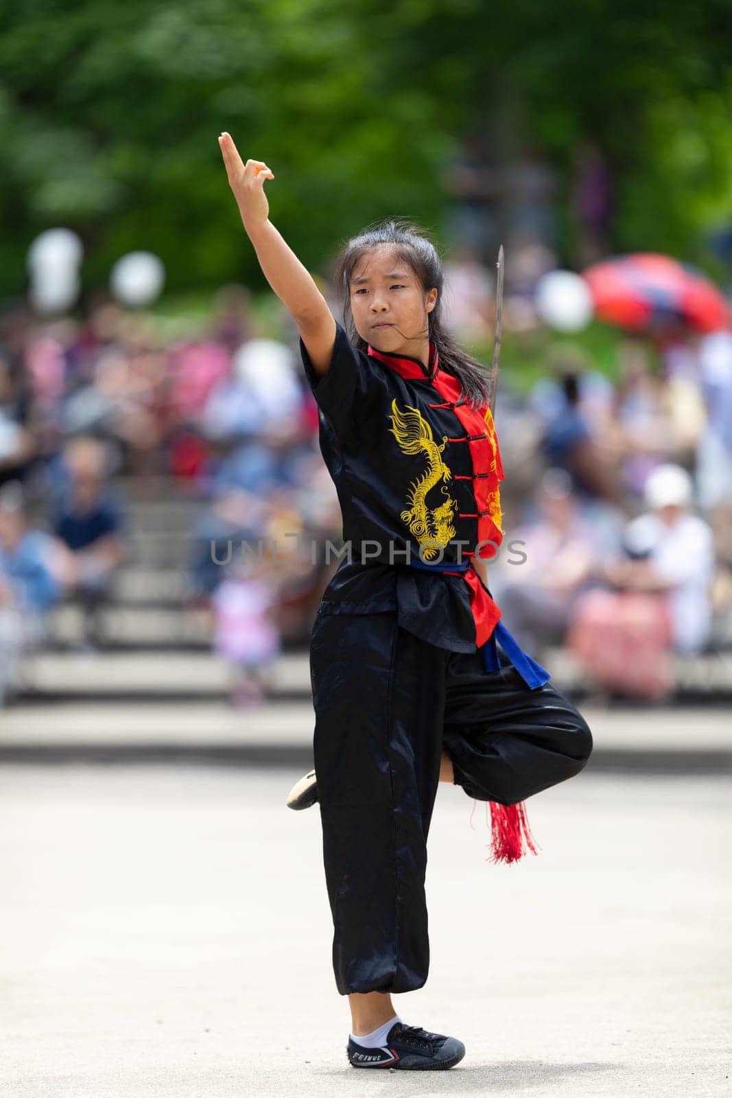 Columbus, Ohio, USA - May 26, 2019: Columbus Asian Festival, Franklin Park, woman wearing traditional chinese clothing handling a Kungfu broadsword during the festival
