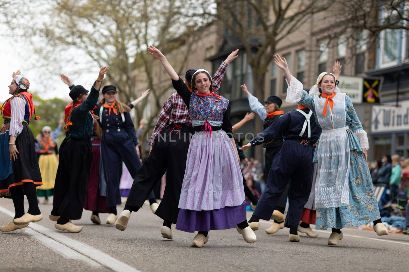 Holland, Michigan, USA - May 11, 2019: Tulip Time Festival, Young women wearing traditional Dutch Clothing dancing in the streets of Holland, Michigan during the Festival