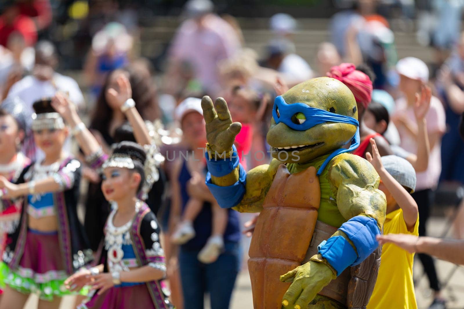 Columbus, Ohio, USA - May 26, 2019: Columbus Asian Festival, members of the spectators wearing traditional clothing, dancing to Bhangra traditional dance in the amphitheater at Franklin Park
