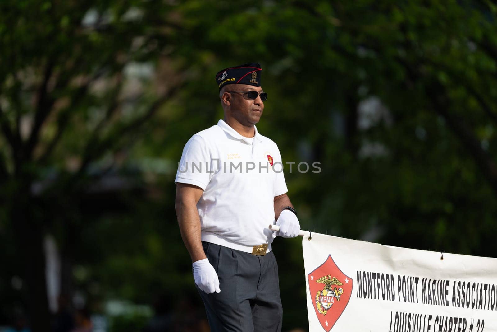 Louisville, Kentucky, USA - May 2, 2019: The Pegasus Parade, Man carrying a banner promoting Montford Marine Association during the parade
