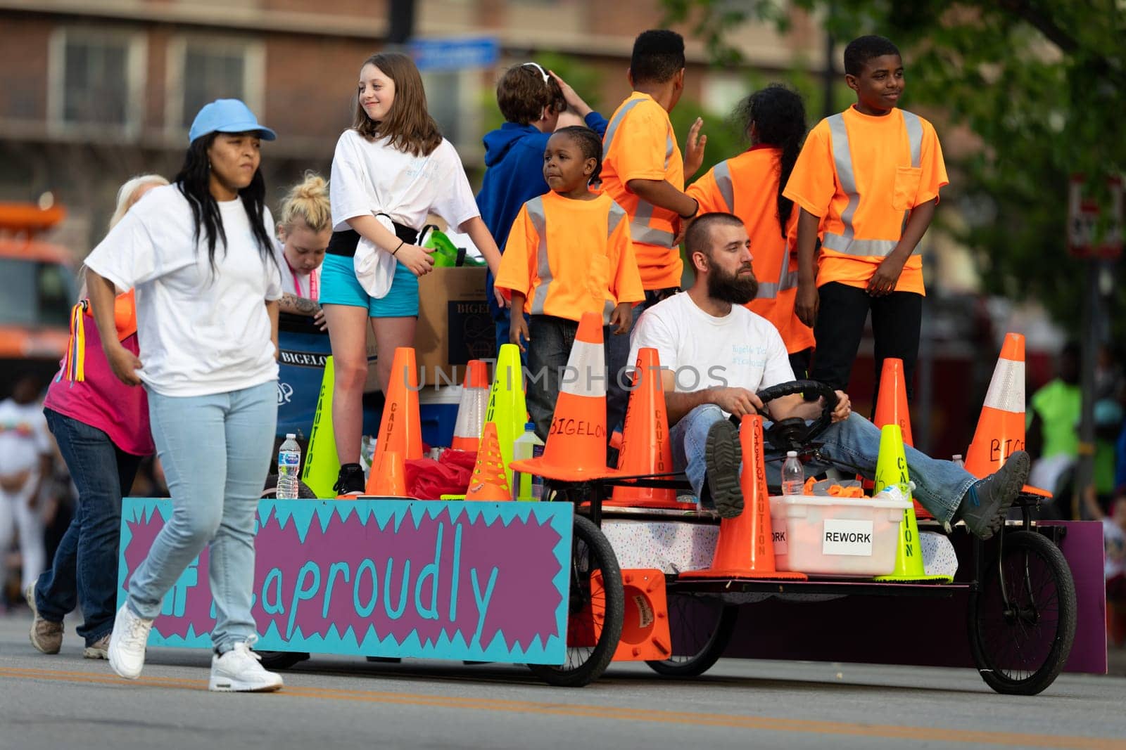 Louisville, Kentucky, USA - May 2, 2019: The Pegasus Parade, Man driving a racing bed, down the street during the parade