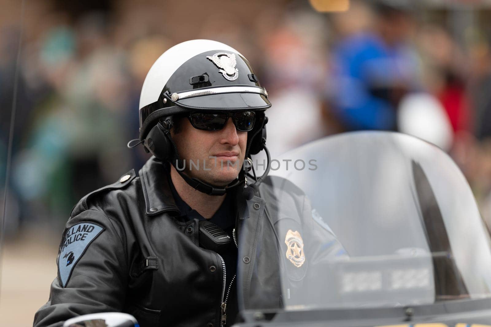 Holland, Michigan, USA - May 11, 2019: Tulip Time Parade, Holland Police Officer riding a motorcycle prior to the parade
