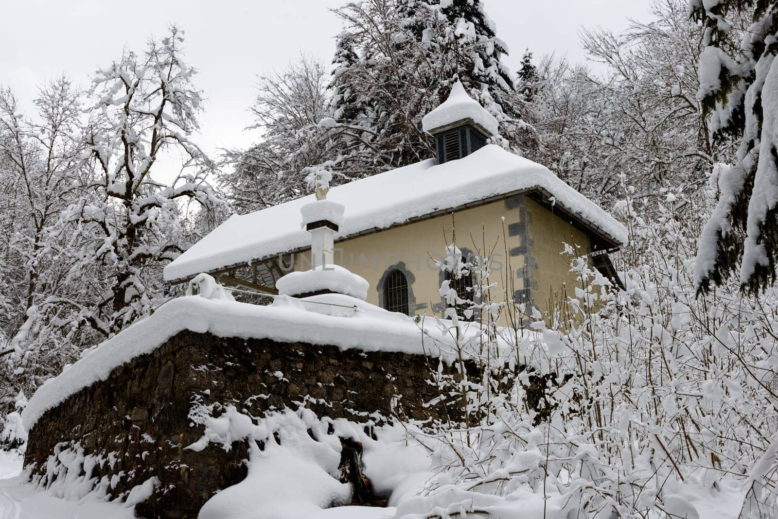 small chapel in the forest in the snow