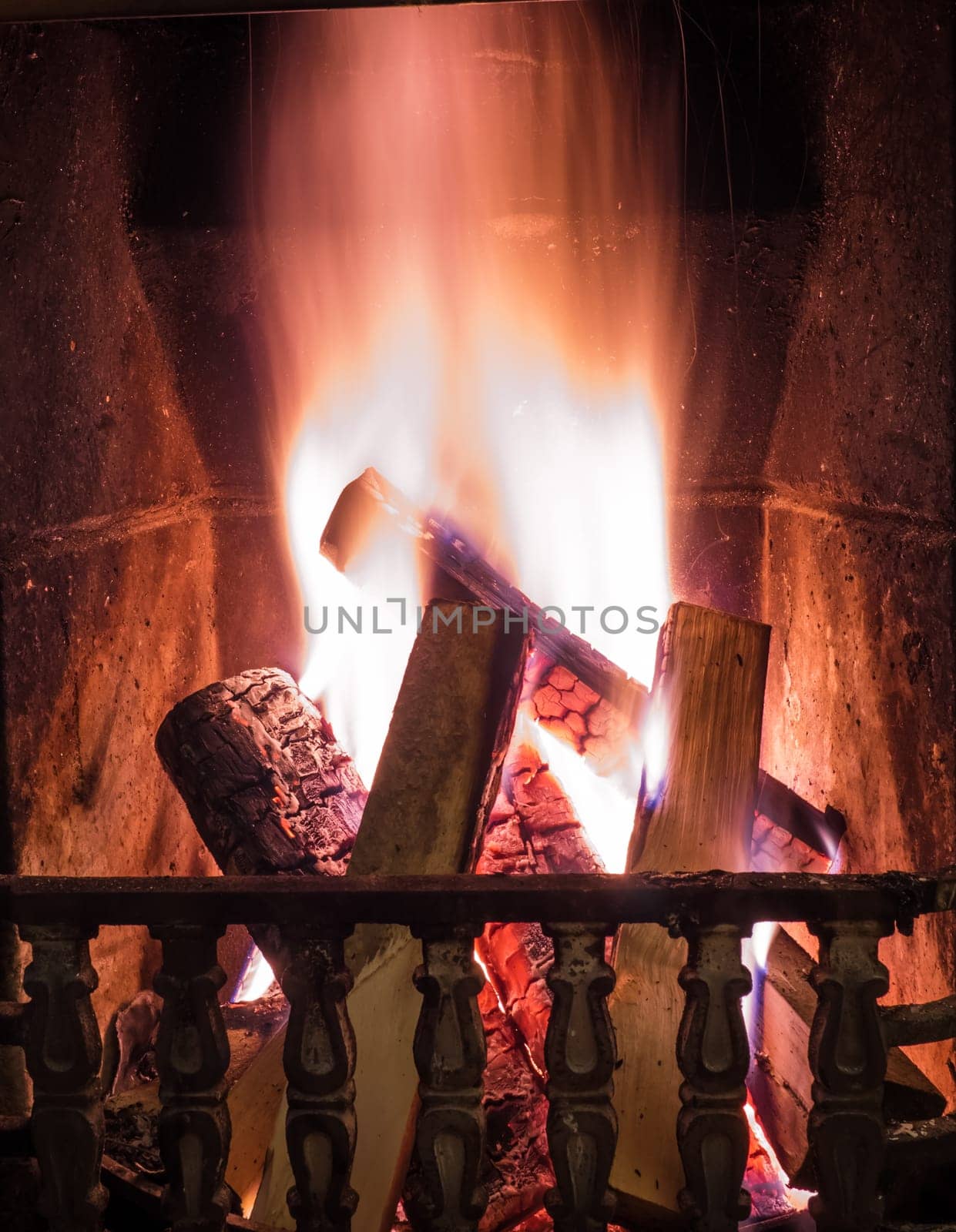 Burning fire in the fireplace. Cosy place
