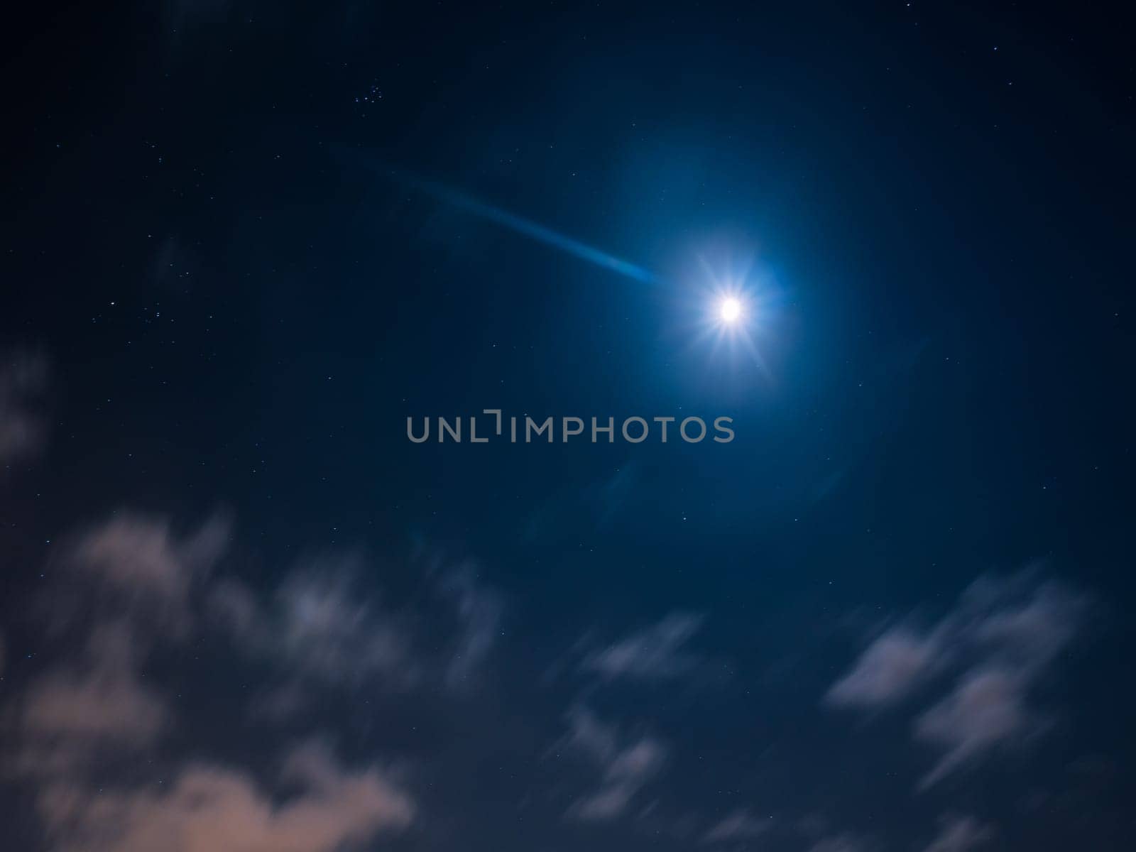 Night cloudy sky with stars and moon