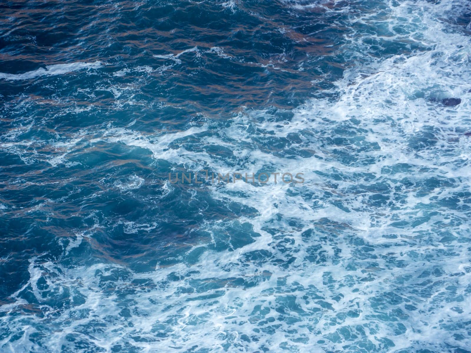 Splashing waves with white foam in ocean