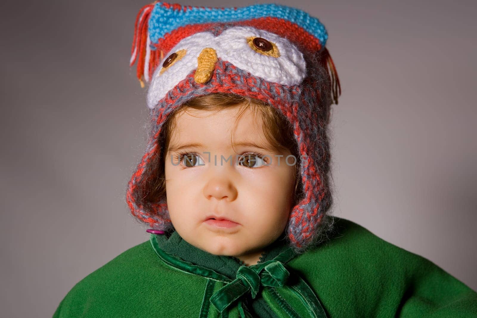 young baby portrait on a grey background
