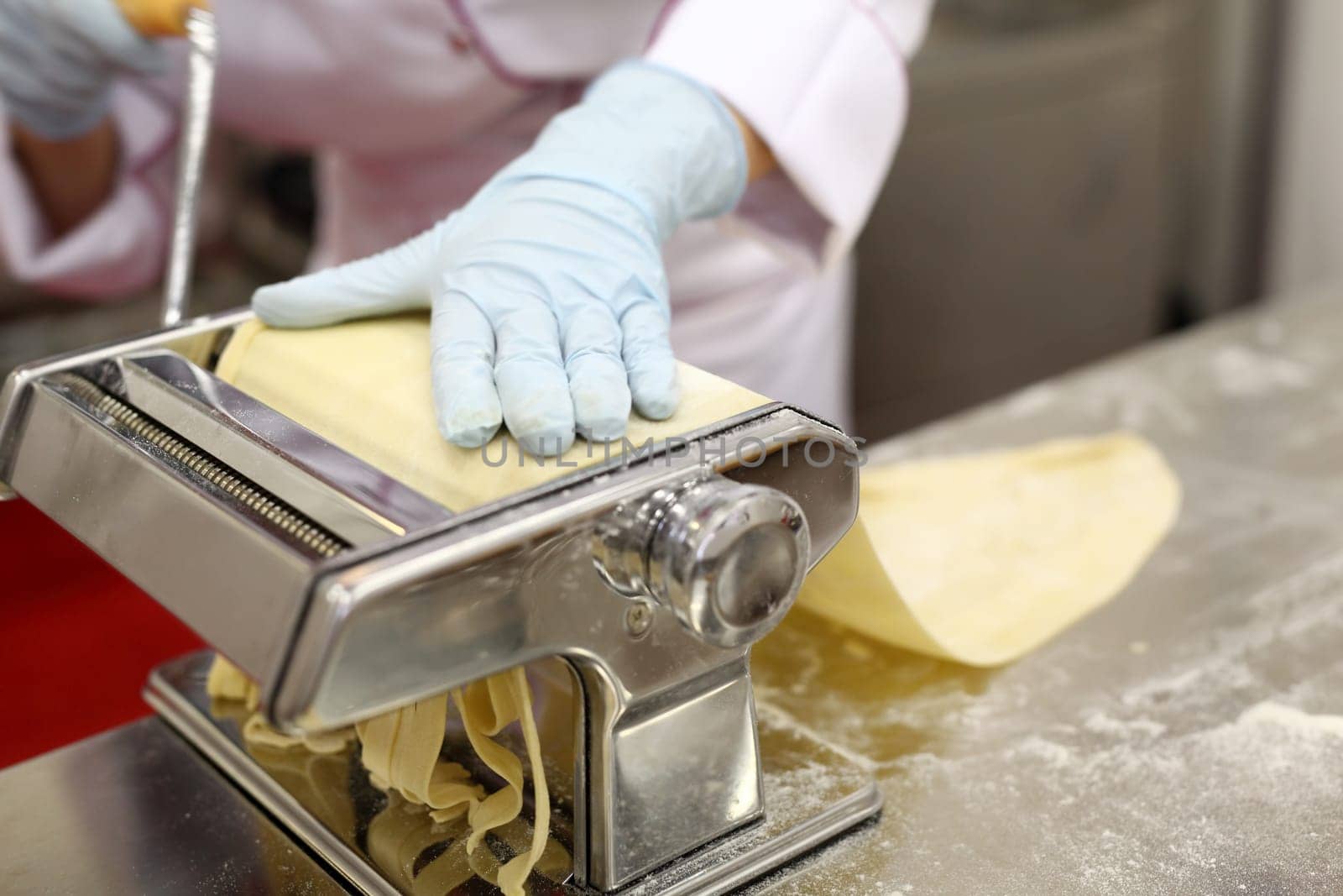 A chef is preparing handmade fresh pasta fettuccine and ravioli