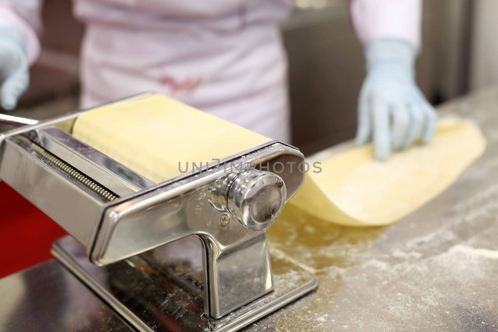 A chef is preparing handmade fresh pasta fettuccine and ravioli