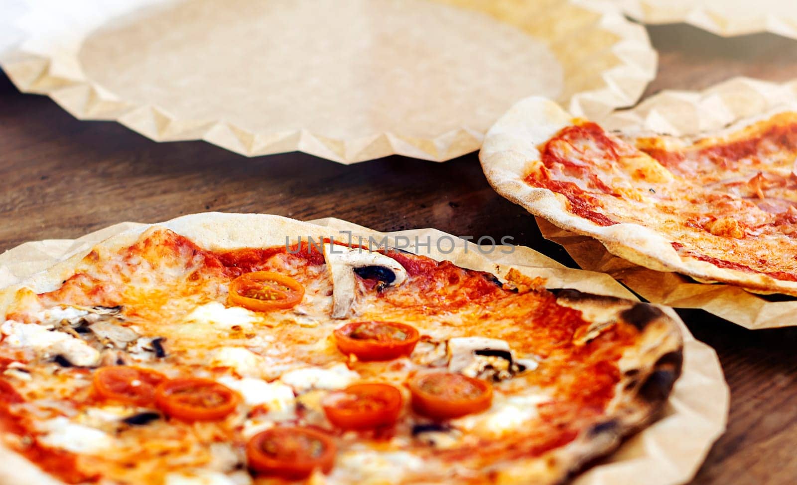 Freshly baked margherita pizza topped with tomato sauce, mozzarella and mushrooms. Typical recipe of Italian cuisine