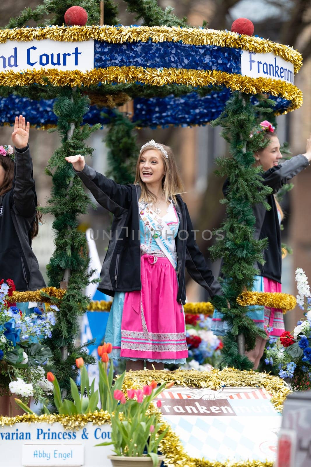 Holland, Michigan, USA - May 11, 2019: Tulip Time Parade, The Bravarian Princess and Court, riding on a float, smiling and waving at spectators