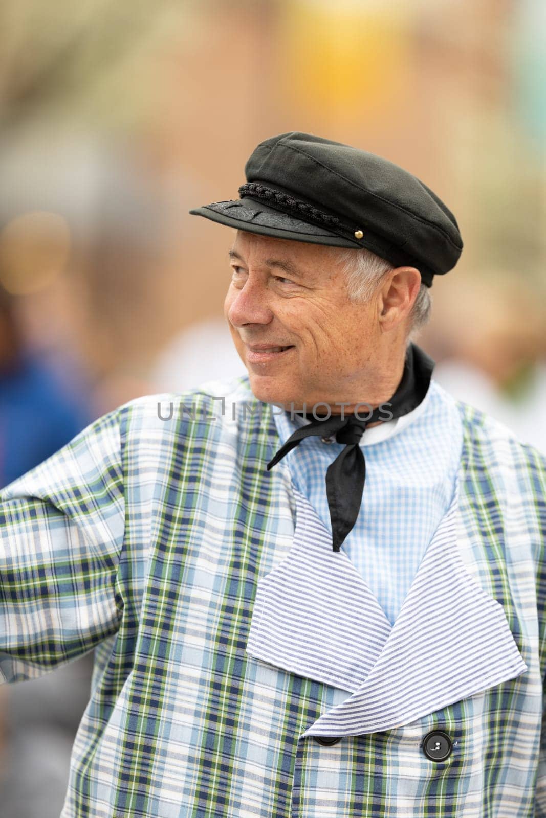 Holland, Michigan, USA - May 11, 2019: Tulip Time Parade, Man wearing traditional dutch clothing, smiling waving at people, going down the road during the parade
