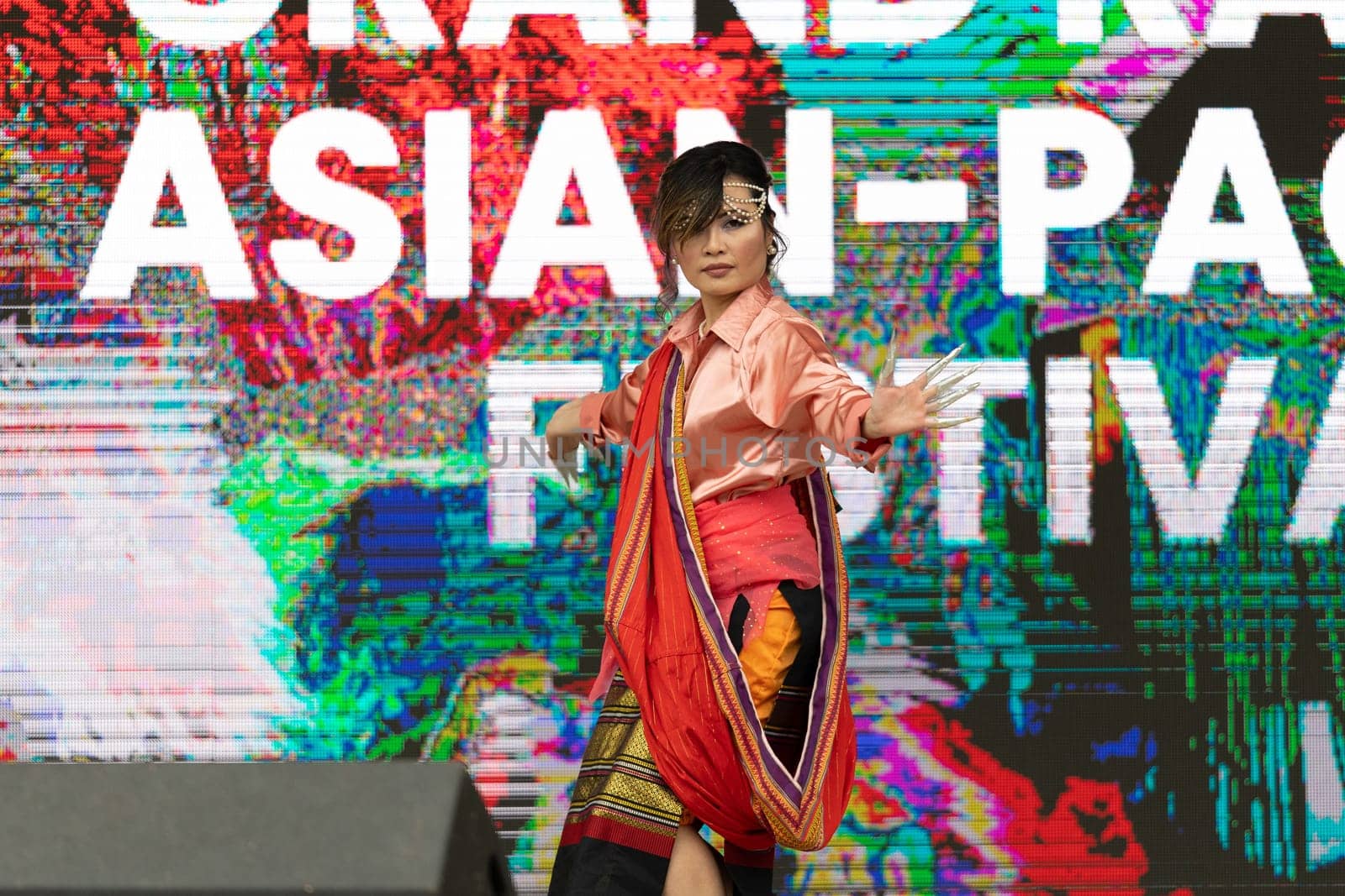 Grand Rapids, Michigan, USA - June 15, 2019: Asian Pacific Festival, Filipino woman wearing traditional clothing performing a traditional dance during the festival at the Rosa Parks Circle