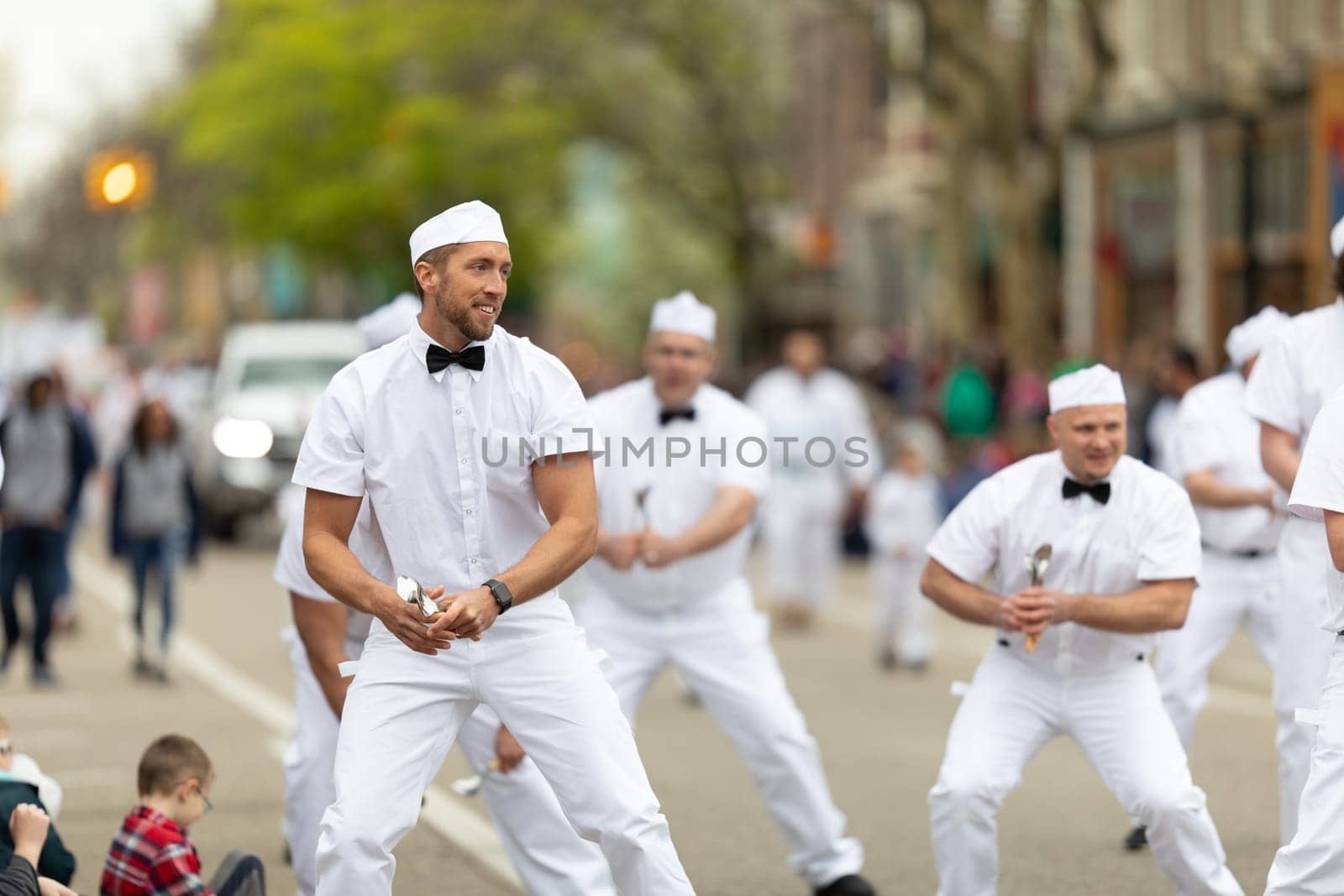 Holland, Michigan, USA - May 11, 2019: Tulip Time Parade, A group of Male Dancers in Uniform, promoting the Hudsonville Ice Cream during the parade