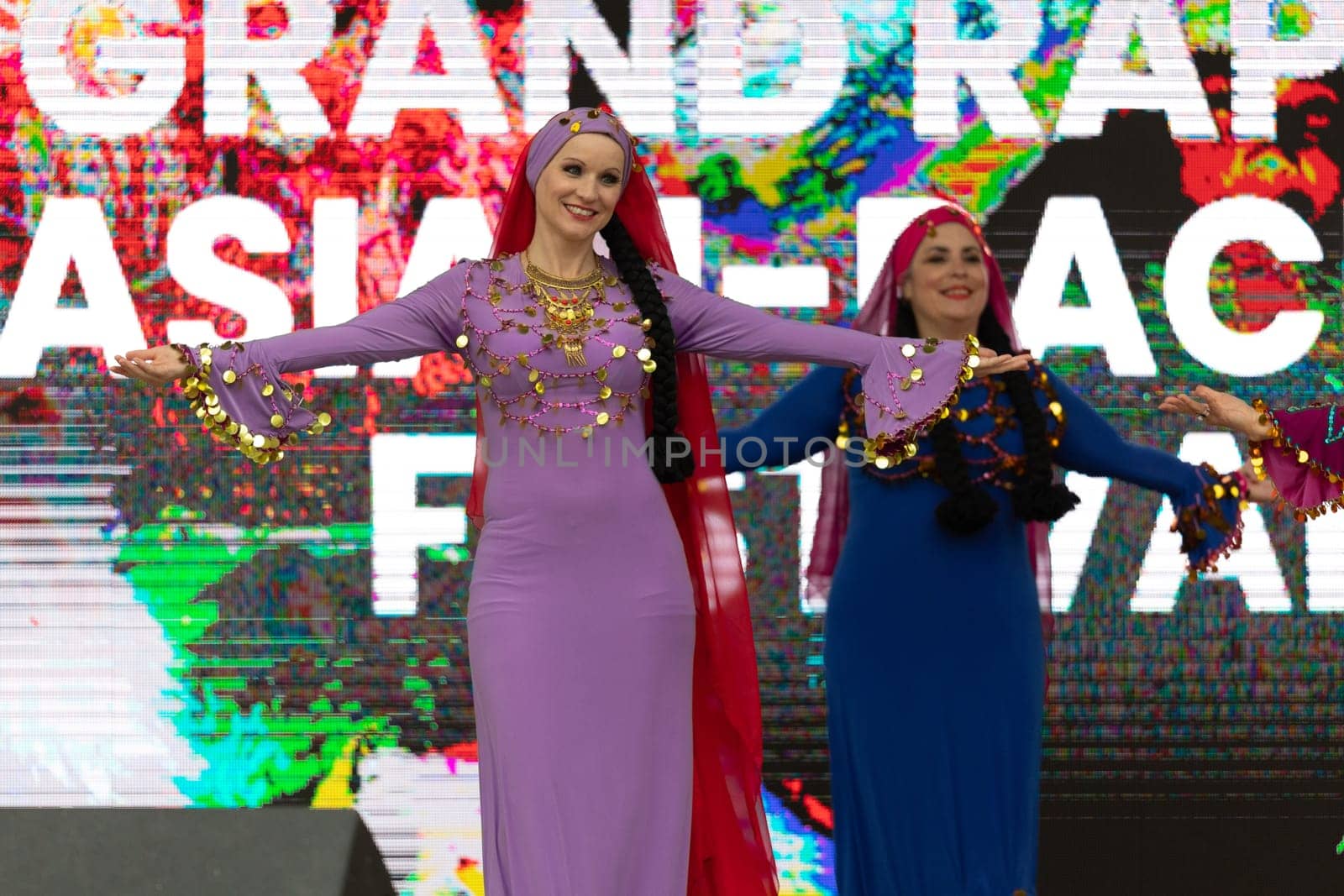 Grand Rapids, Michigan, USA - June 15, 2019: Asian Pacific Festival, Women wearing traditional Egyptian clothing performing traditional dance at the Rosa Parks Circle