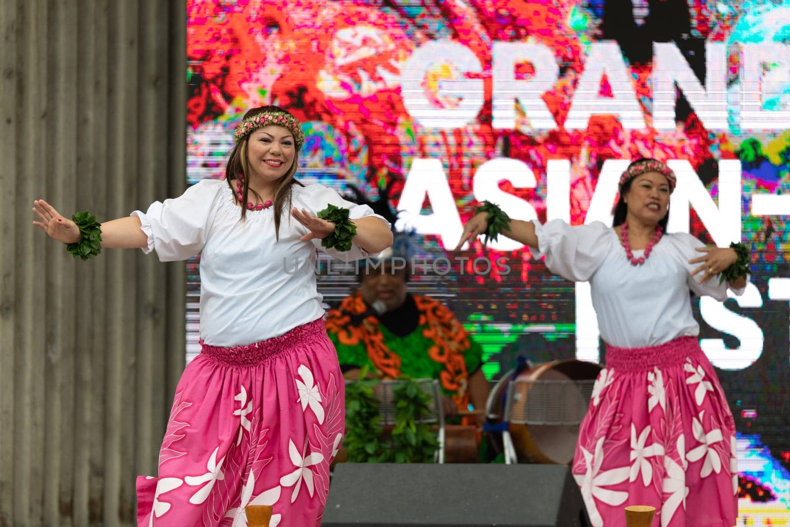 Grand Rapids, Michigan, USA - June 15, 2019: Asian Pacific Festival, Woman wearing traditional clothing performing a hula dance at the Rosa Parks Circle
