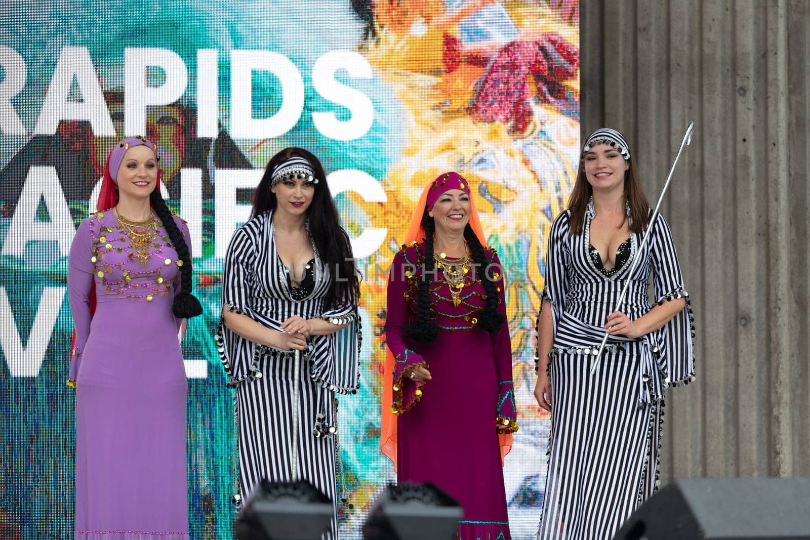 Grand Rapids, Michigan, USA - June 15, 2019: Asian Pacific Festival, Women wearing traditional Egyptian clothing performing traditional dance at the Rosa Parks Circle