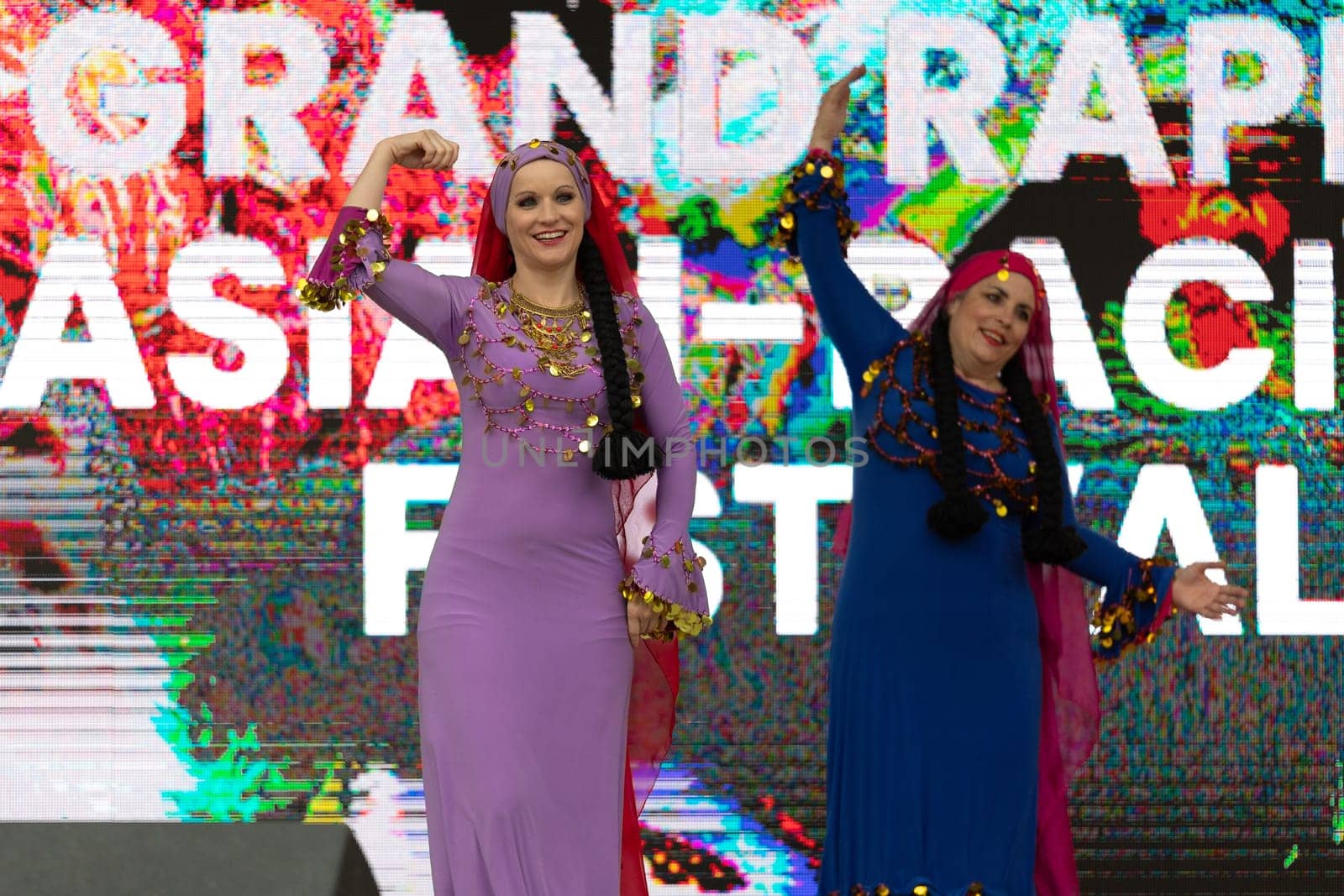 Grand Rapids, Michigan, USA - June 15, 2019: Asian Pacific Festival, Women wearing traditional Egyptian clothing performing traditional dance at the Rosa Parks Circle