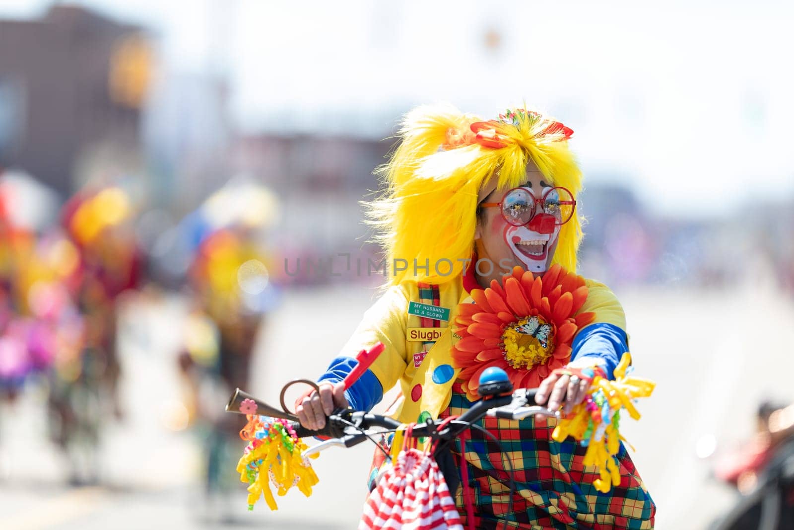 Benton Harbor, Michigan, USA - May 4, 2019: Blossomtime Festival Grand Floral Parade, Michiana Clowns riding bicycles during the parade