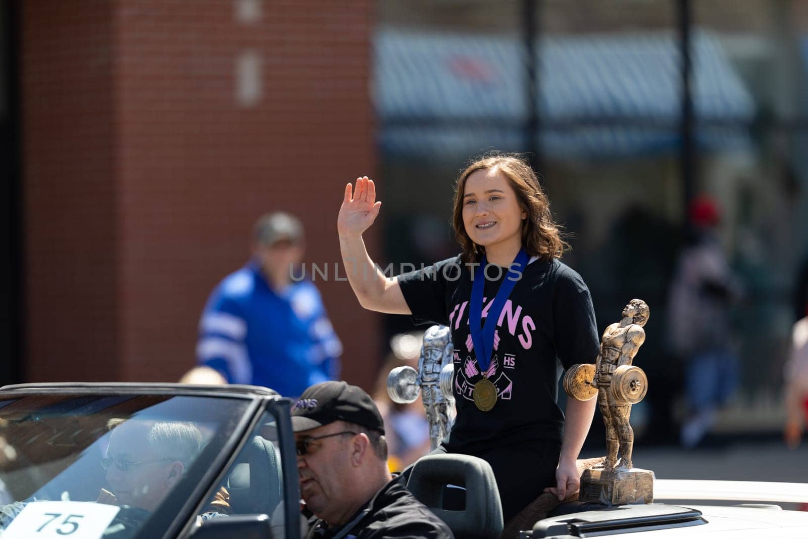 Benton Harbor, Michigan, USA - May 4, 2019: Blossomtime Festival Grand Floral Parade, car transportinf Michigan state Champion Powerlifting during the parade