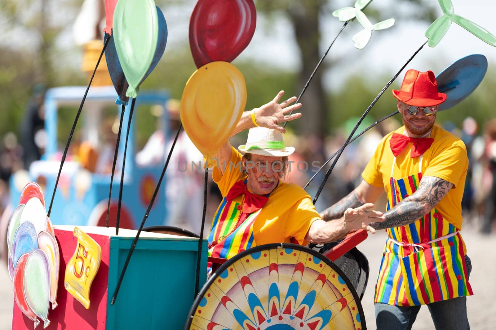 Cleveland, Ohio, USA - June 8, 2019: Parade the Circle, man riding on a wheelchair that looks like a balloon vendor cart