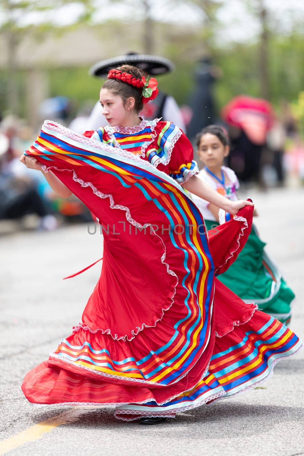 Cleveland, Ohio, USA - June 8, 2019: Parade the Circle, young woman wearing traditional mexican clothing dancing