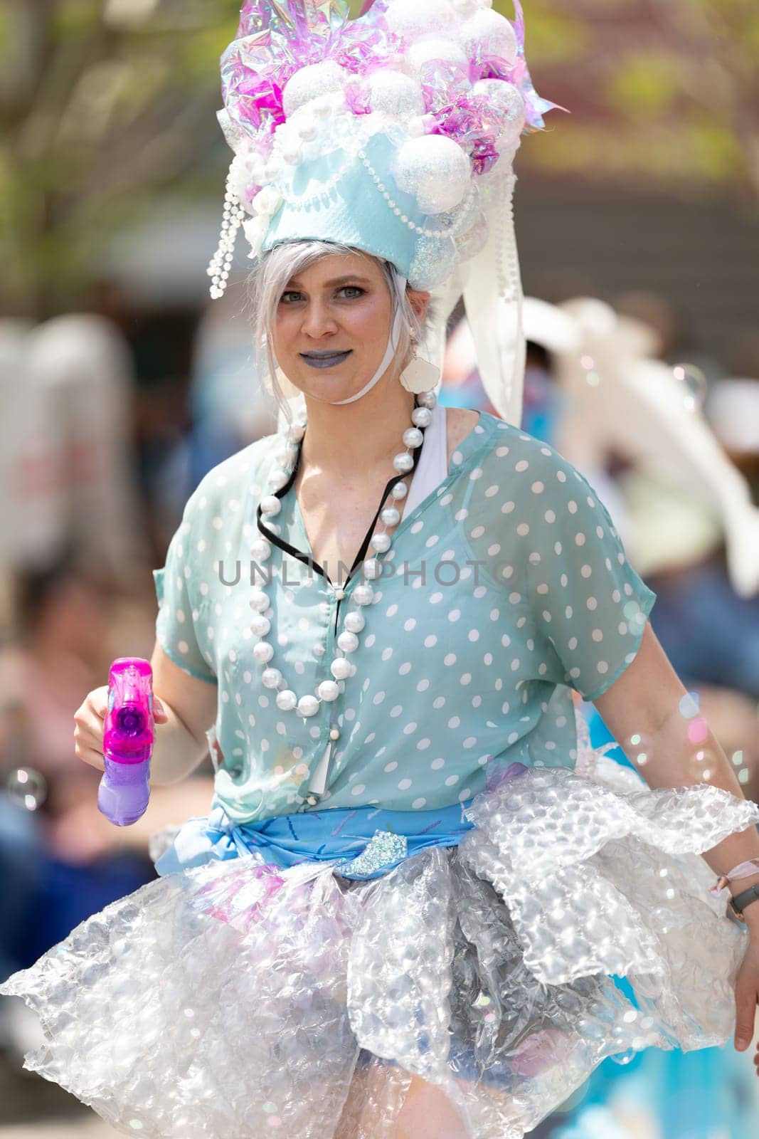 Cleveland, Ohio, USA - June 8, 2019: Parade the Circle, woman using a bubble gun during the parade