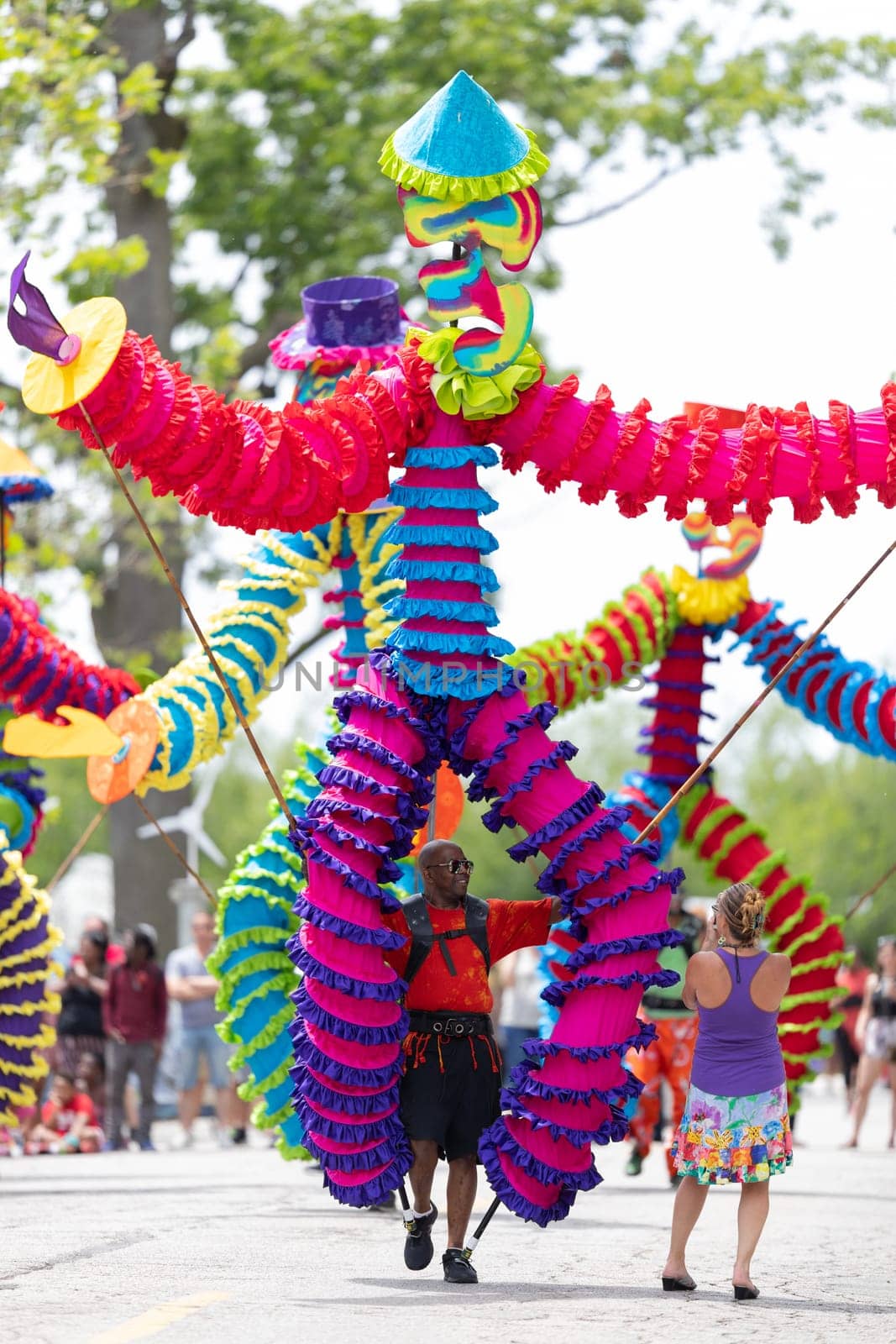 Cleveland, Ohio, USA - June 8, 2019: Parade the Circle, african american man carrying large puppets at the parade