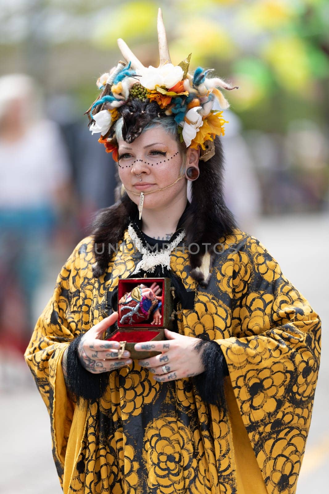 Cleveland, Ohio, USA - June 8, 2019: Parade the Circle, woman wearing a colorful outfit with horns during the parade