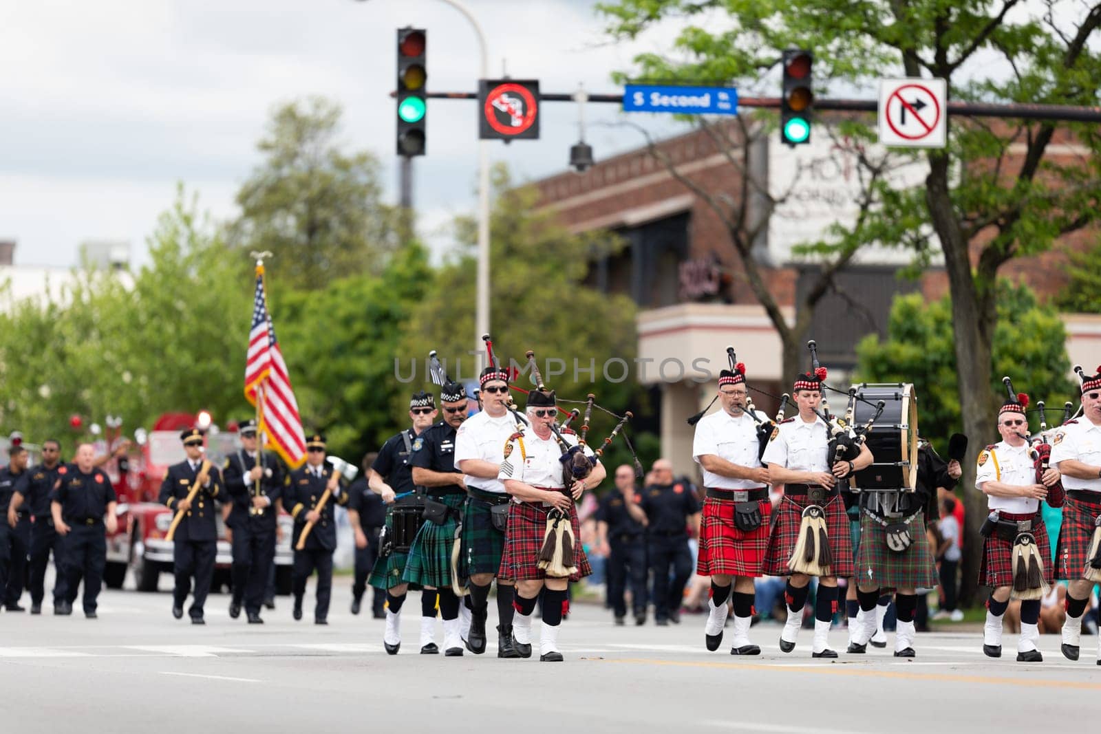 Louisville, Kentucky, USA - May 2, 2019: The Pegasus Parade, Members of the  Louisville Fire & Rescue Pipes and Drums, performing at the parade