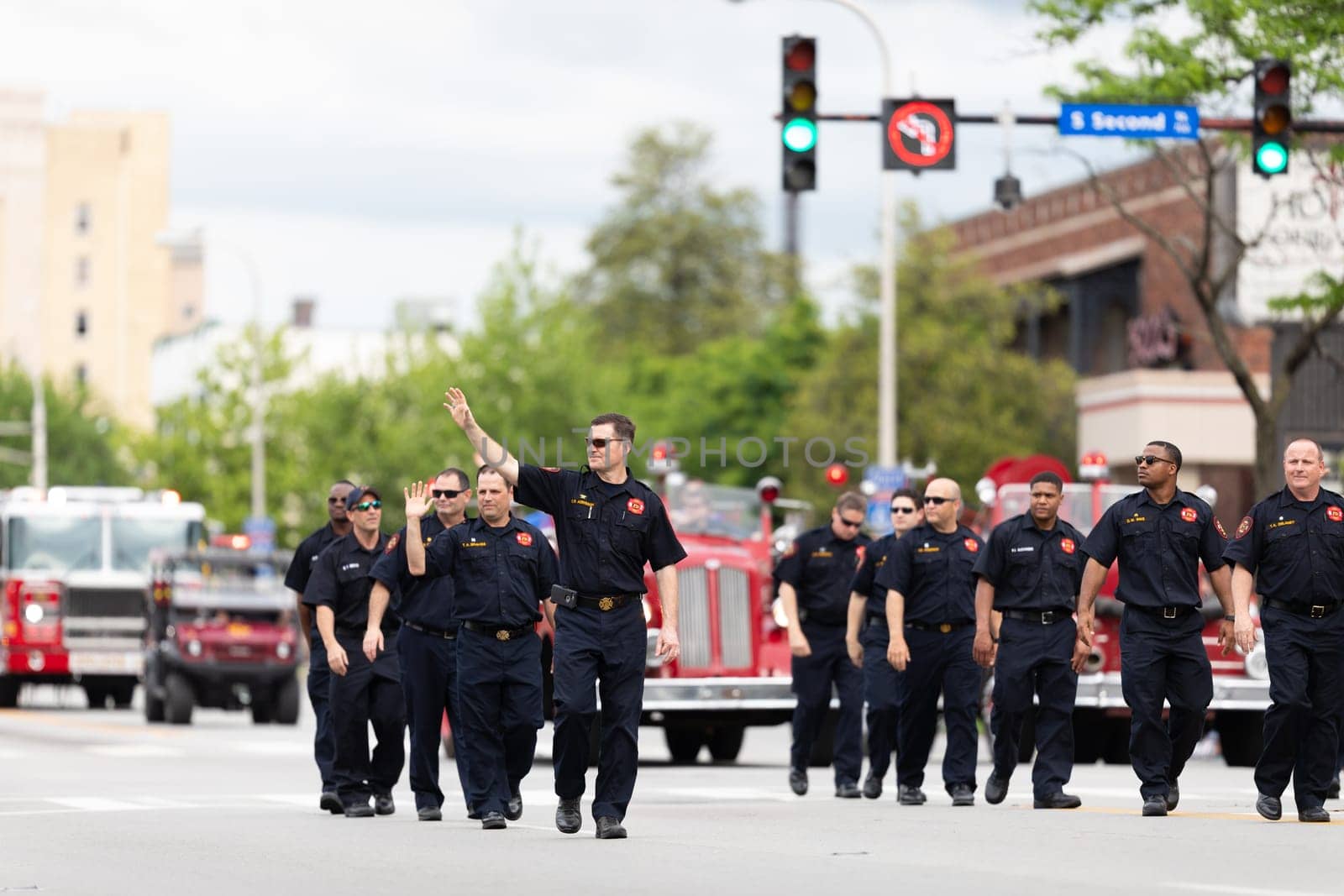 Louisville, Kentucky, USA - May 2, 2019: The Pegasus Parade, Members of the fire department marching down the street during the parade
