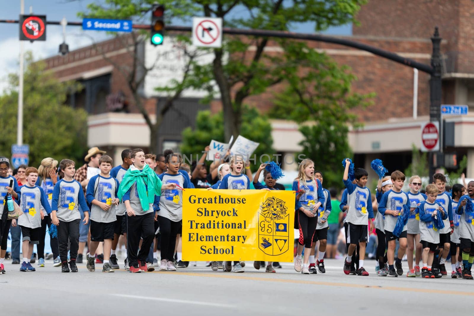 Louisville, Kentucky, USA - May 2, 2019: The Pegasus Parade, Members of the Greathouse Shryock Traditional Elementary School, carrying hunger awareness signs during the parade