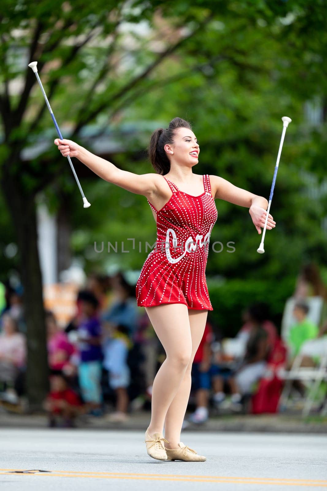 Louisville, Kentucky, USA - May 2, 2019: The Pegasus Parade, Members of the University of Louisville cheerleaders and marching band performing at the parade