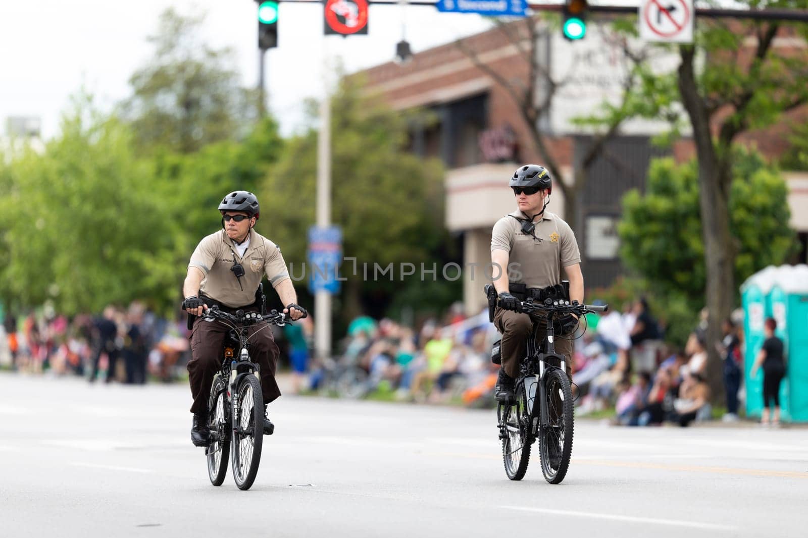 Louisville, Kentucky, USA - May 2, 2019: The Pegasus Parade, Sheriff on bicycles riding along parade route prior to the parade